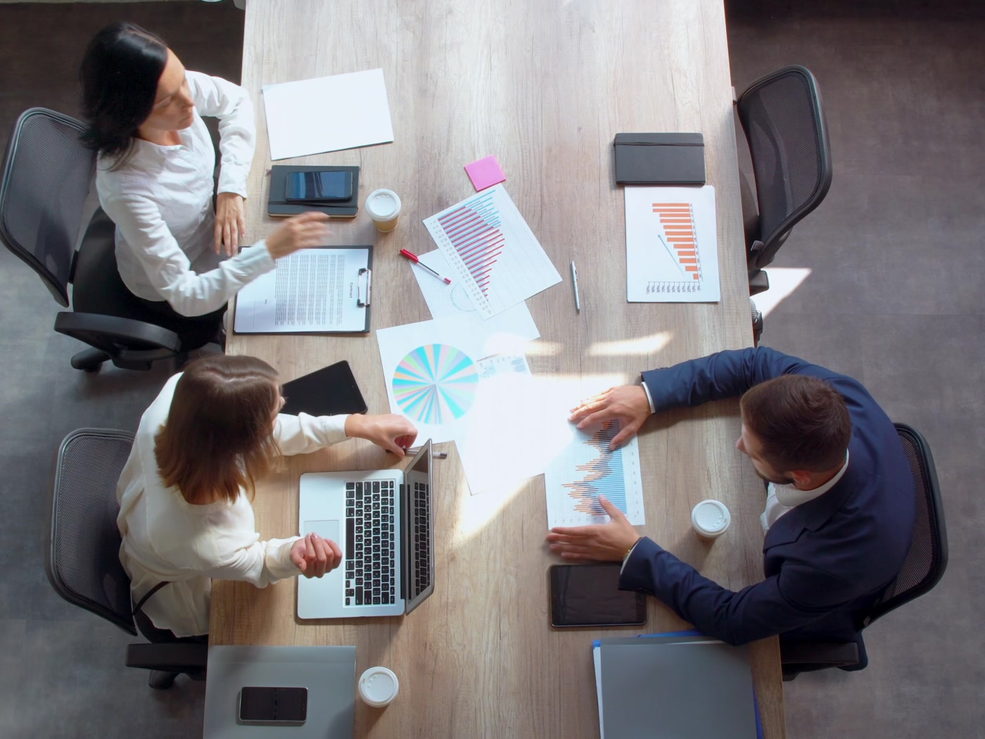 People reviewing business information around a meeting table